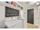 Functional laundry room with modern appliances and built-in shelving at 624 N Ashbrook Cir, Mesa, AZ 85213