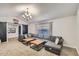 Comfortable living room featuring a large sectional sofa, and sliding barn door at 624 N Ashbrook Cir, Mesa, AZ 85213
