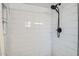 Clean and modern shower with white subway tiles and a sleek black shower head at 624 N Ashbrook Cir, Mesa, AZ 85213