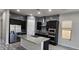 Modern kitchen with granite countertops, stainless steel appliances, and ample storage space in dark cabinets at 6621 E Villa Rita Dr, Phoenix, AZ 85054