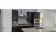 Stylish kitchen with dark cabinets, granite countertops, stainless steel appliances, and a sleek range hood at 6621 E Villa Rita Dr, Phoenix, AZ 85054