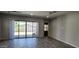 Bright living room with sliding glass doors to patio, showcasing modern wood-look flooring and neutral walls at 6621 E Villa Rita Dr, Phoenix, AZ 85054