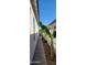 Narrow side yard showing brick pavers between the home and the block fence at 6621 E Villa Rita Dr, Phoenix, AZ 85054