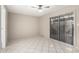 This is a spacious bedroom with tile flooring and a sliding glass door at 6818 N 35Th Ave # C, Phoenix, AZ 85017