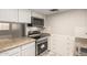 Efficient kitchen featuring white cabinetry, granite countertops, and stainless steel oven at 6818 N 35Th Ave # C, Phoenix, AZ 85017