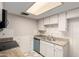 Functional kitchen with white cabinets, granite countertops, and tiled backsplash with ample counter space at 6818 N 35Th Ave # C, Phoenix, AZ 85017