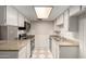 Efficient kitchen with white cabinetry, granite countertops, and modern stainless steel appliances at 6818 N 35Th Ave # C, Phoenix, AZ 85017