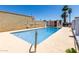 Community pool area with shallow steps, a safety handrail, and mature palm trees at 6818 N 35Th Ave # C, Phoenix, AZ 85017