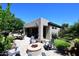 Beautiful backyard patio features a cozy fire pit, comfortable seating, and desert landscaping at 6937 E Purple Shade Cir, Scottsdale, AZ 85266