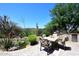 Relaxing backyard oasis features a dining table, outdoor grill, and desert landscaping at 6937 E Purple Shade Cir, Scottsdale, AZ 85266