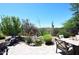 Beautiful backyard featuring pond, mature landscaping, and comfortable seating at 6937 E Purple Shade Cir, Scottsdale, AZ 85266