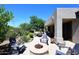 Beautiful backyard patio features a cozy fire pit, comfortable seating, and desert landscaping at 6937 E Purple Shade Cir, Scottsdale, AZ 85266