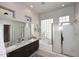 Bright bathroom featuring double sinks, granite countertops, and separate tub and shower at 6937 E Purple Shade Cir, Scottsdale, AZ 85266