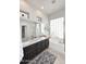 Bathroom featuring double sinks, granite countertops, a soaking tub, and a glass block window for privacy at 6937 E Purple Shade Cir, Scottsdale, AZ 85266
