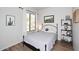 Cozy bedroom featuring hardwood floors, window with curtains, and neutral decor at 6937 E Purple Shade Cir, Scottsdale, AZ 85266
