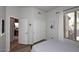 Comfortable bedroom featuring wood floors, window with curtains, and ensuite at 6937 E Purple Shade Cir, Scottsdale, AZ 85266