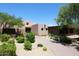 Desert-style clubhouse with desert landscaping and a circular driveway at 6937 E Purple Shade Cir, Scottsdale, AZ 85266