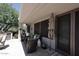 Covered patio with comfortable seating, outdoor umbrella, and access to an outdoor kitchen at 6937 E Purple Shade Cir, Scottsdale, AZ 85266