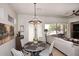 An inviting dining area next to the living room features stylish lighting and a view of the outdoor patio at 6937 E Purple Shade Cir, Scottsdale, AZ 85266