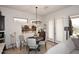 Bright dining area featuring an elegant chandelier, a round table with seating, and French doors at 6937 E Purple Shade Cir, Scottsdale, AZ 85266