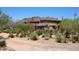 Exterior view of desert home with native landscaping and mountain views at 6937 E Purple Shade Cir, Scottsdale, AZ 85266