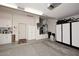 Spacious garage featuring epoxy floors, cabinets, and ample storage space at 6937 E Purple Shade Cir, Scottsdale, AZ 85266