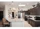 Spacious kitchen with dark cabinets, stainless steel appliances, and a large granite island at 6937 E Purple Shade Cir, Scottsdale, AZ 85266