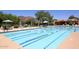 Community swimming pool with clear blue water, lane markers, and lounge seating at 6937 E Purple Shade Cir, Scottsdale, AZ 85266