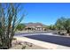 A serene street view showcases a home against a backdrop of majestic mountains and lush desert landscape at 6937 E Purple Shade Cir, Scottsdale, AZ 85266