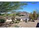 Scenic view of a desert home with mature landscaping and mountain backdrop at 6937 E Purple Shade Cir, Scottsdale, AZ 85266