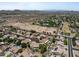 Expansive aerial view of a desert community featuring luxurious homes, pools, and scenic mountain views in the distance at 7315 W Monte Lindo Ln, Glendale, AZ 85310