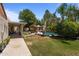 Expansive backyard featuring a pool, tiki bar, tropical landscaping, and covered patio, perfect for entertaining at 7315 W Monte Lindo Ln, Glendale, AZ 85310