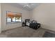 A bedroom featuring carpet, a window, a ceiling fan, and a bed with decorative pillows at 7315 W Monte Lindo Ln, Glendale, AZ 85310