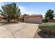 Suburban home with a three-car garage, xeriscape landscaping, and a tile roof at 7315 W Monte Lindo Ln, Glendale, AZ 85310