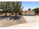 Charming single-story home featuring desert landscaping, a spacious driveway, and a two-car garage at 7315 W Monte Lindo Ln, Glendale, AZ 85310