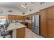 Bright kitchen featuring stainless steel appliances, wood cabinets, and a kitchen island with bar stools at 7315 W Monte Lindo Ln, Glendale, AZ 85310