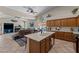 Open-concept kitchen with island, stainless steel appliances, and seamless flow into the adjacent living area at 7315 W Monte Lindo Ln, Glendale, AZ 85310