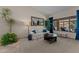 Relaxing living room with a comfortable sofa, stylish decor, and a view of the outdoor tiki bar at 7315 W Monte Lindo Ln, Glendale, AZ 85310