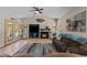 Comfortable living room featuring a fireplace, large TV, and access to outdoor spaces at 7315 W Monte Lindo Ln, Glendale, AZ 85310