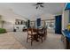 Combined dining and living area with views of the backyard pool and a cozy atmosphere at 7315 W Monte Lindo Ln, Glendale, AZ 85310
