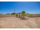 Spacious backyard featuring a pergola, xeriscaping and potential for landscaping and outdoor activities at 7324 S 254Th Dr, Buckeye, AZ 85326
