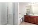 Primary bathroom view featuring a glass enclosed shower, soaking tub, and vanity at 7324 S 254Th Dr, Buckeye, AZ 85326