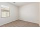Carpeted bedroom featuring natural light and neutral color palette at 7324 S 254Th Dr, Buckeye, AZ 85326