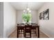 The dining room has modern decor, neutral paint and floors, and a view of the outdoors at 7324 S 254Th Dr, Buckeye, AZ 85326