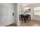 The front door leads to a dining area with a dark wood table and tile flooring at 7324 S 254Th Dr, Buckeye, AZ 85326