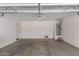 Spacious garage featuring concrete flooring, a water heater, and ample space for storage at 7324 S 254Th Dr, Buckeye, AZ 85326