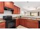 The kitchen boasts granite countertops, wood cabinets, and seamlessly connects to the living room at 7324 S 254Th Dr, Buckeye, AZ 85326