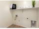 Functional laundry room featuring a shelf, laundry-themed decor, and connections for a washer and dryer at 7324 S 254Th Dr, Buckeye, AZ 85326