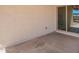Simple outdoor patio area with a sliding glass door, offering potential for relaxation and backyard access at 7324 S 254Th Dr, Buckeye, AZ 85326