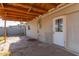 Covered back patio with stone flooring, offering a quaint outdoor living space at 7619 W Clarendon Ave, Phoenix, AZ 85033